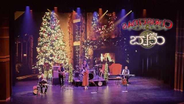 The Celts performing on a stage that is decorated for Christmas, next the words Christmas with the Celts